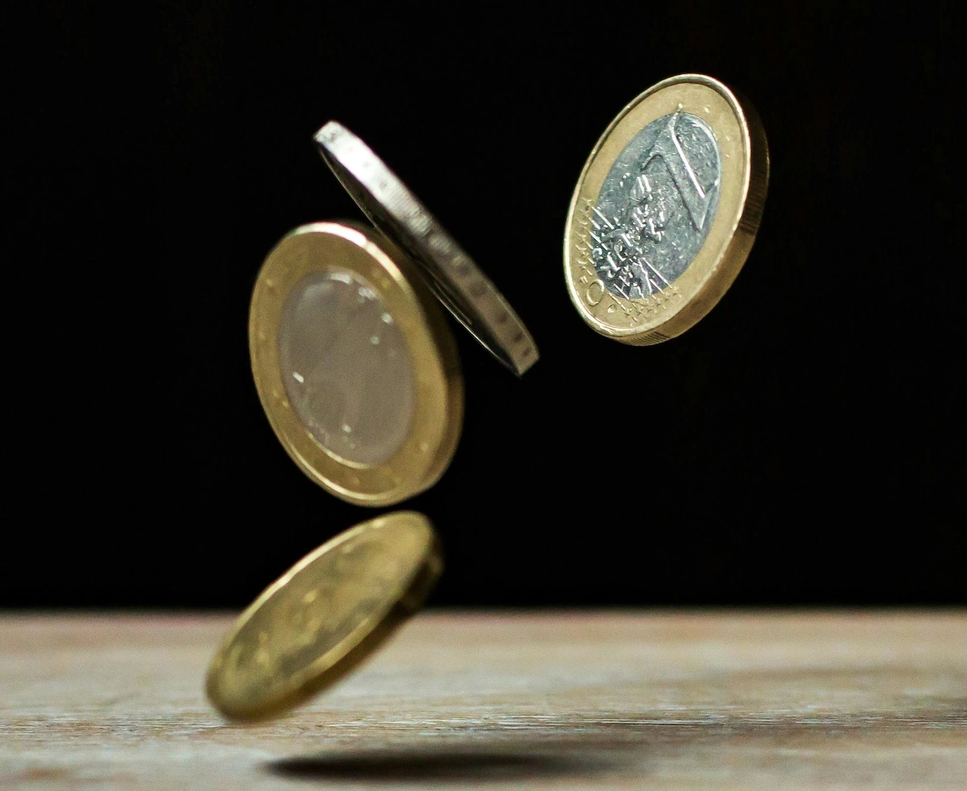 Coins on brown wood